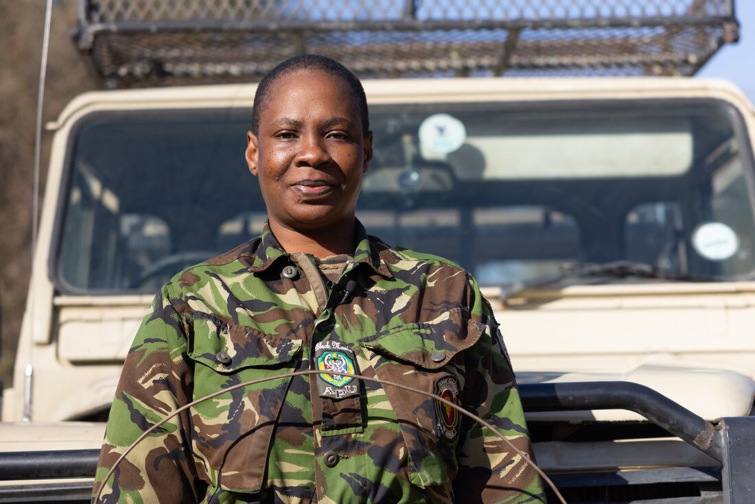 Black Mamba member poses for photo in front of jeep, Botswana, South Africa